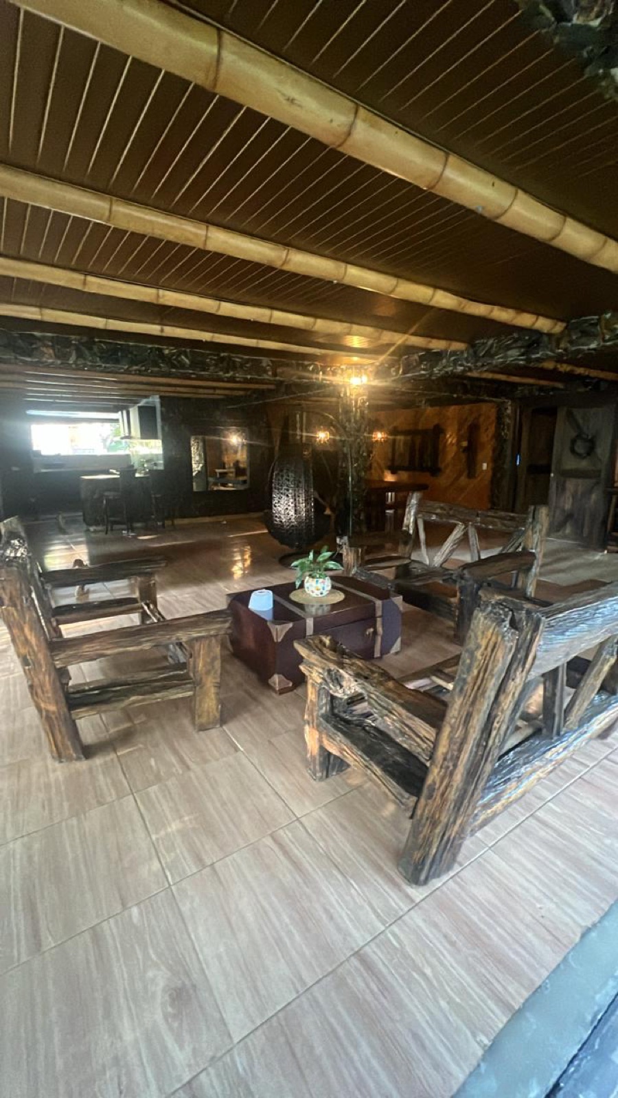 The hand-built common area — bamboo ceilings, carved furniture