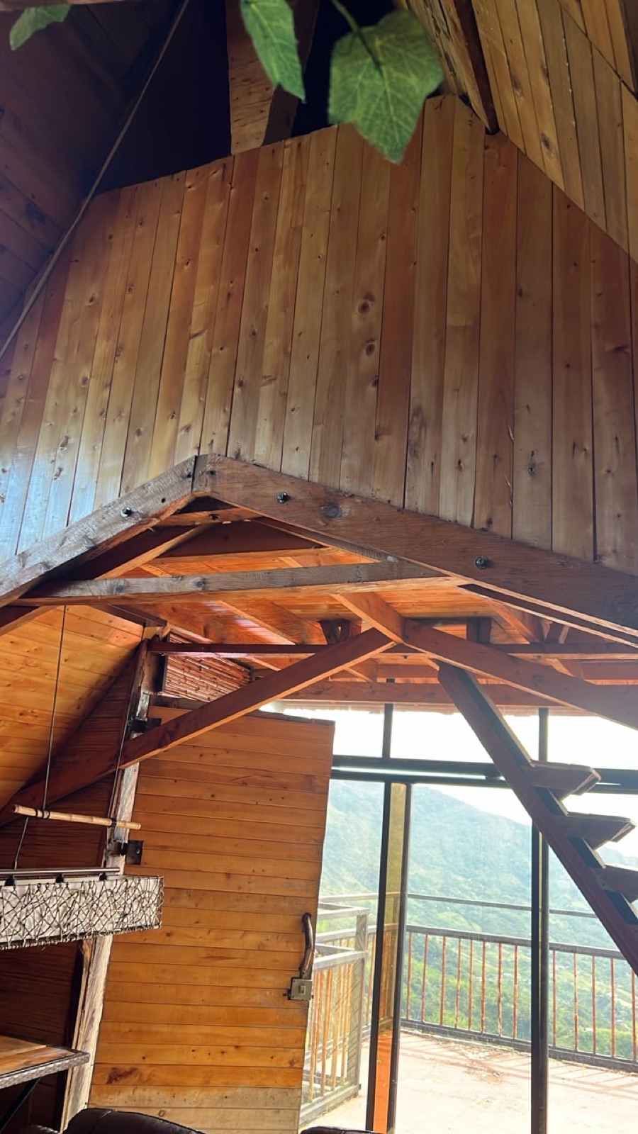 Inside the A-frame — glass wall to the valley