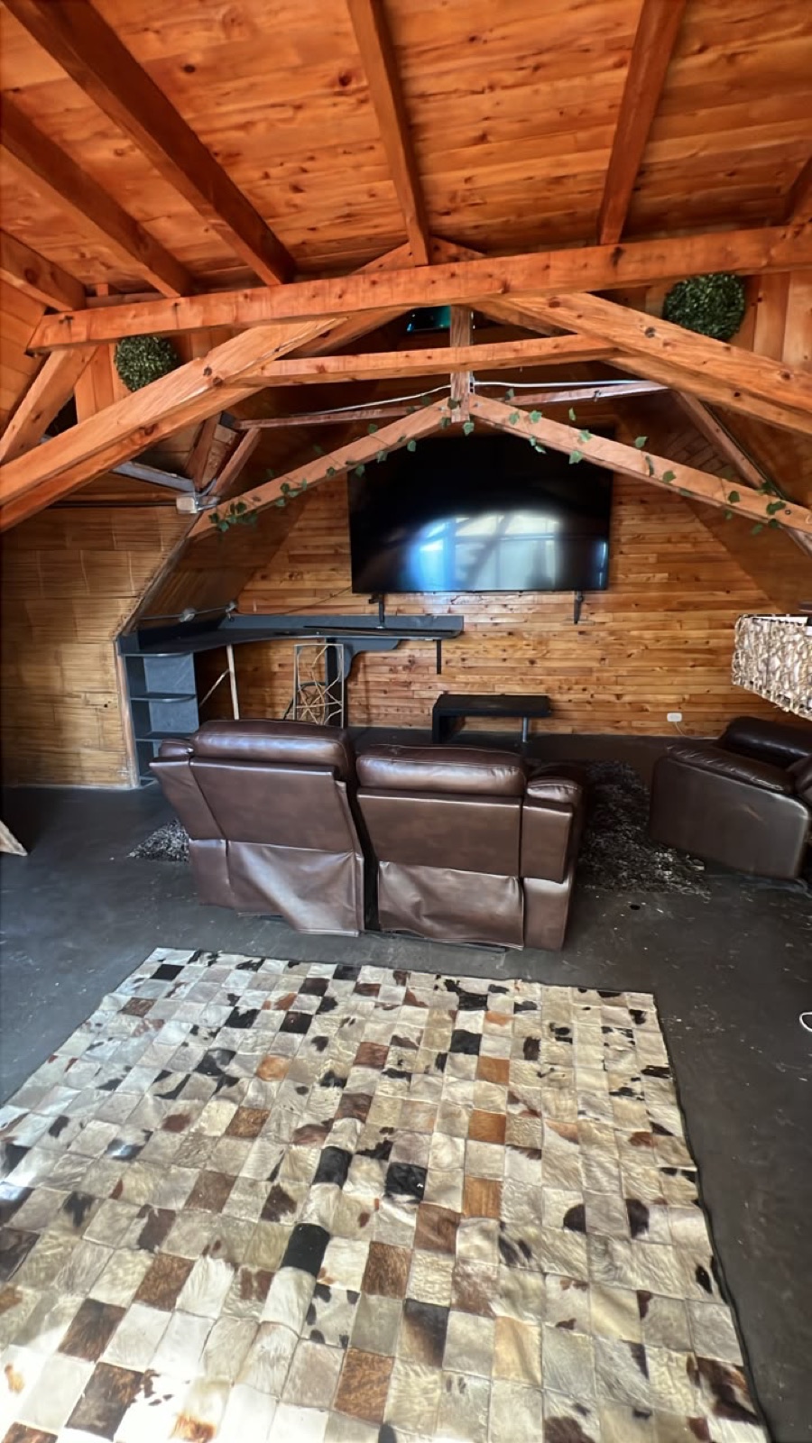 The loft lounge — recliners, big screen, cowhide